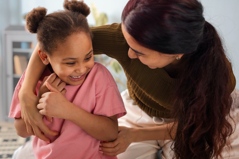 Caregiver sharing a hug with a smiling girl